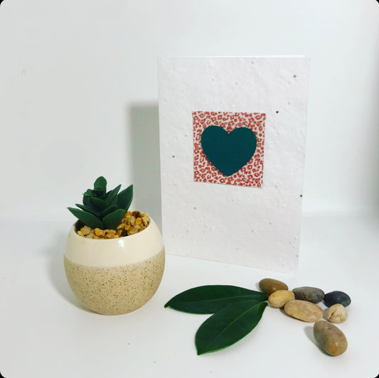 Seeded, plantable greeting card, with green hand painted 'heart' motif with embossed leopard background