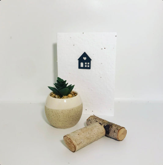 Seeded, plantable greeting card. With hand painted, green, wooden 'house' motif on embossed background