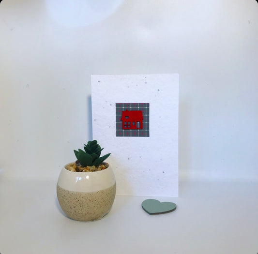 Seeded, plantable greeting card. With hand painted red house motif with tartan background.